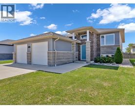 A modern house with a realtor logo on the image.