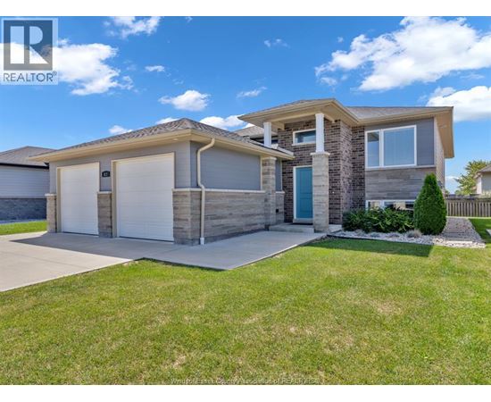 A modern house with a realtor logo on the image.