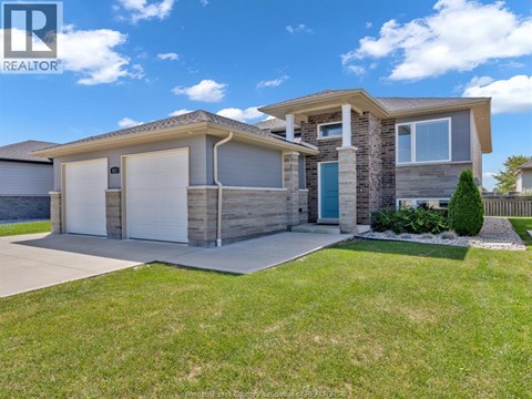 A modern house with a realtor logo on the image.