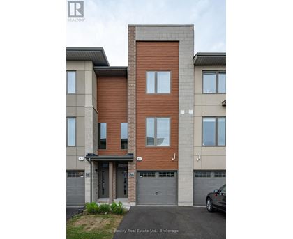 A modern two-story building with a garage on the ground floor.