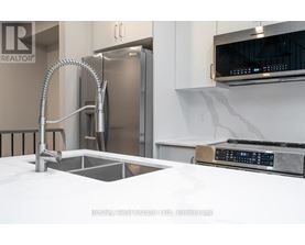 A modern kitchen with a stainless steel refrigerator and a white countertop.