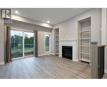 A spacious living room with a fireplace and sliding glass doors.