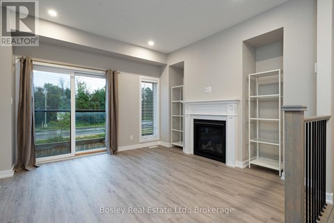 A spacious living room with a fireplace and sliding glass doors.