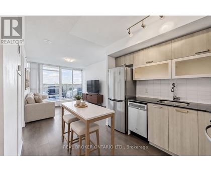A modern kitchen with a dining table and chairs.