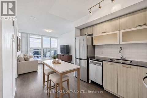 A modern kitchen with a dining table and chairs.