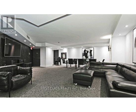 A living room with black leather furniture and a flat screen TV.
