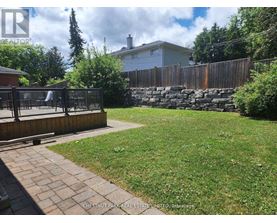 A backyard with a wooden fence and a playground.