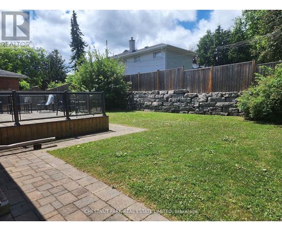 A backyard with a wooden fence and a playground.