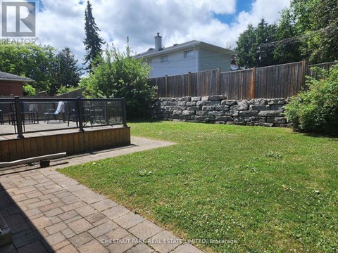 A backyard with a wooden fence and a playground.