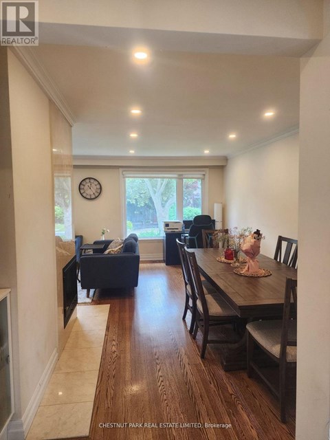 A dining room with a wooden table and chairs.