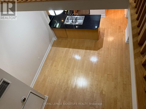 A kitchen with wooden floors and a countertop.