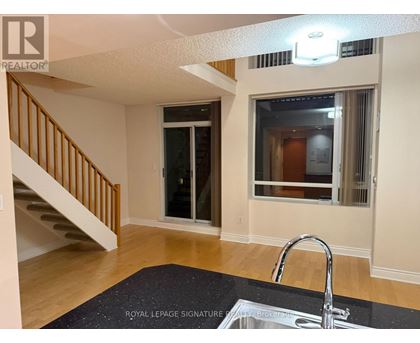 A room with a Royal LePage sign on the floor.
