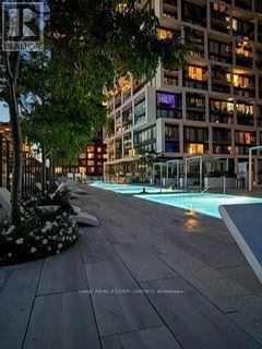A pool in a city setting surrounded by buildings.