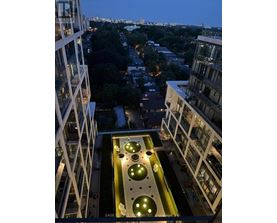A view from a high-rise building looking down at a courtyard with circular lights.