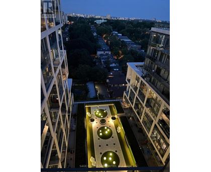 A view from a high-rise building looking down at a courtyard with circular lights.