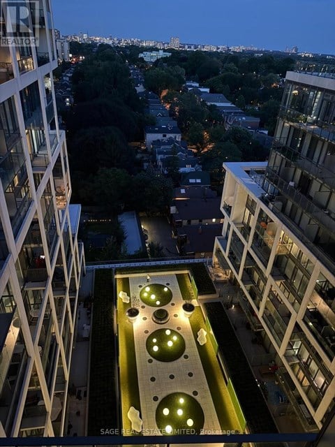 A view from a high-rise building looking down at a courtyard with circular lights.