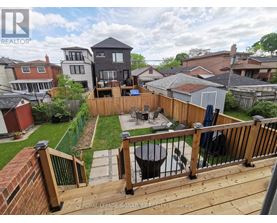 A backyard with a deck and a hot tub.
