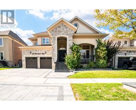 A large house with a stone pillar entrance and a sign that says "The Great Gatsby".
