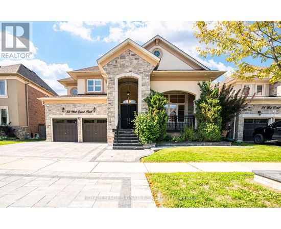 A large house with a stone pillar entrance and a sign that says "The Great Gatsby".