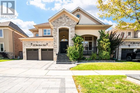 A large house with a stone pillar entrance and a sign that says "The Great Gatsby".