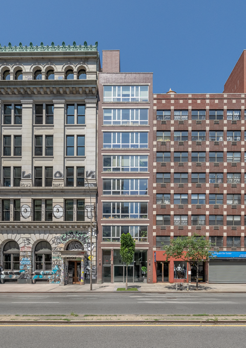 A row of buildings with a blue sky in the background.