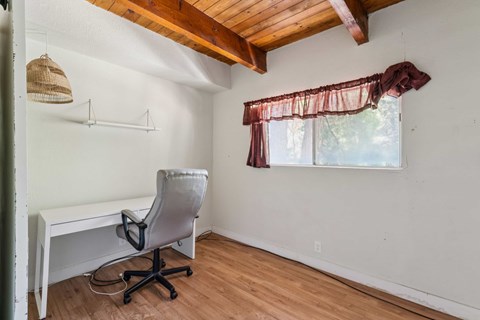 A room with a desk and chair.