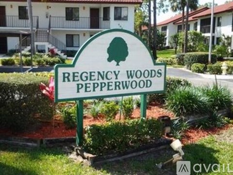 A sign for Regency Woods Pepperwood in front of a building.