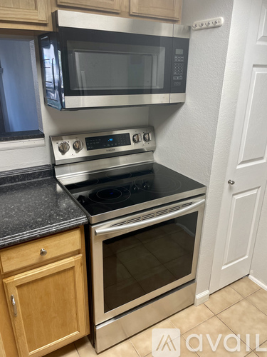 A kitchen with a stainless steel oven and microwave.