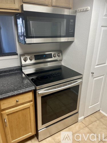A kitchen with a stainless steel oven and microwave.