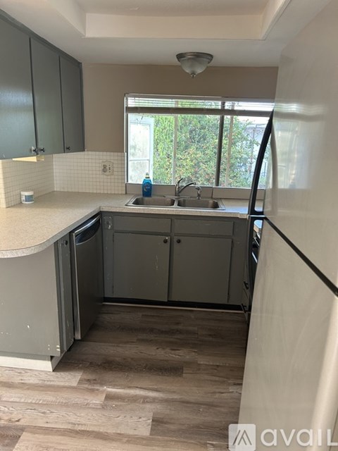 A kitchen with a sink and a window.