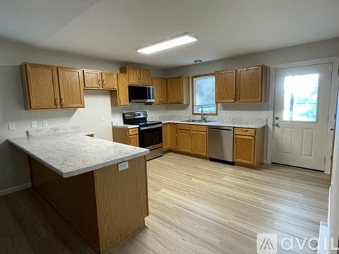 A kitchen with wooden cabinets and a white countertop.