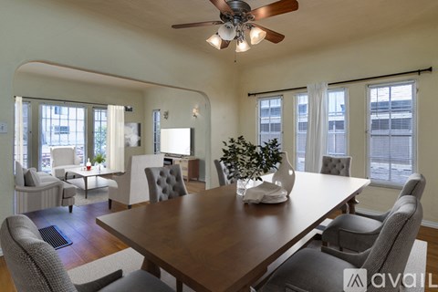 A modern dining room with a large table and chairs.