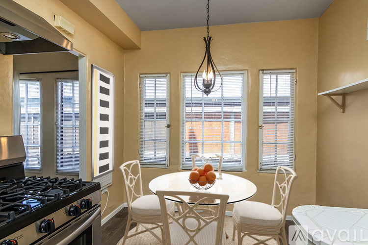 A kitchen with a table and chairs and a stove.
