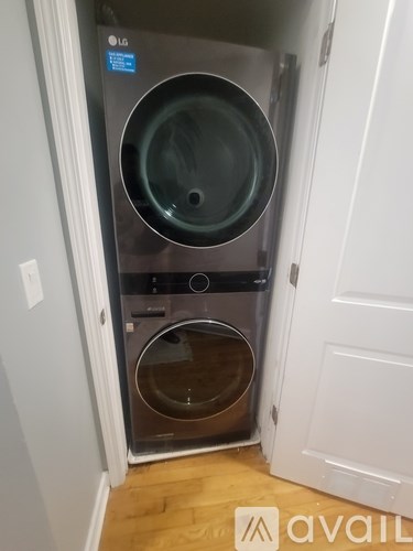 A front-loading LG washing machine in a small room.