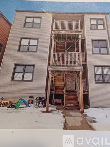 A building with a wooden staircase in front of it.