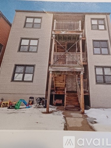 A building with a wooden staircase in front of it.