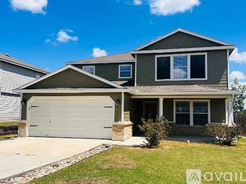 A two-story house with a garage is available for sale.