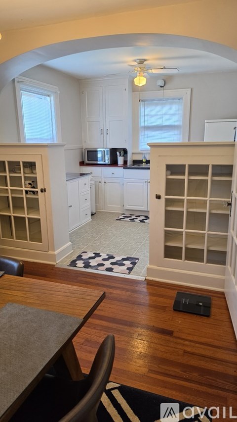 A kitchen with a table and chairs in it.