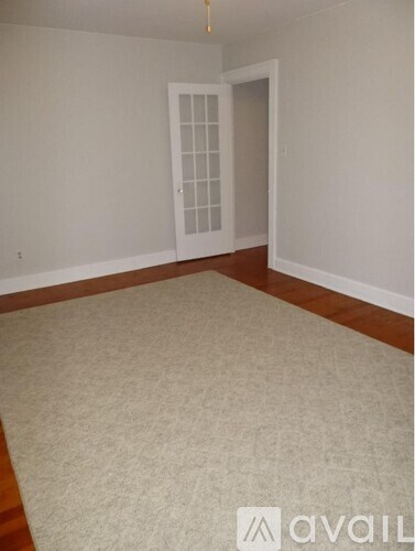 A room with a carpeted floor and a door.