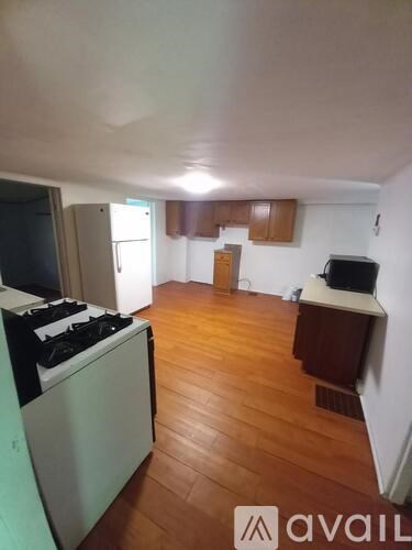 A kitchen with a stove top oven and a refrigerator.