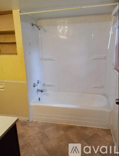 A bathroom with a walk-in shower and a door.