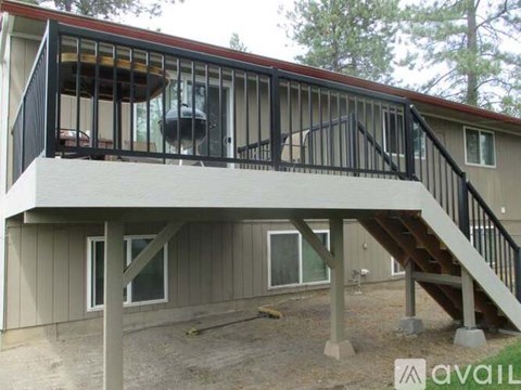A house with a balcony and stairs leading to the second floor.