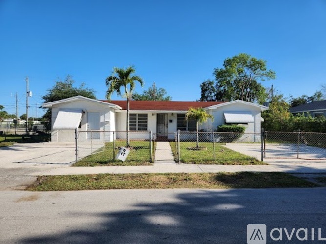 A house with a white fence and a sign that says "available" in front of it.