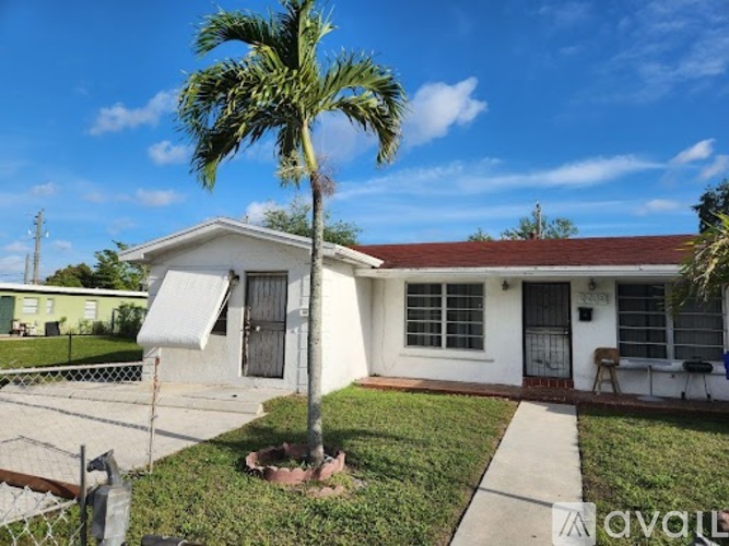 A house with a palm tree in front of it.