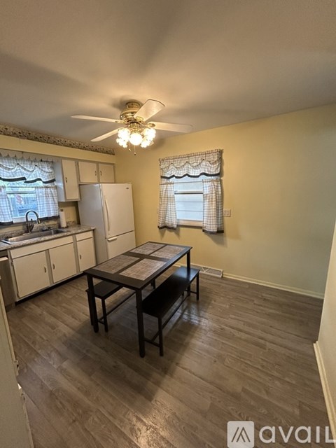 A kitchen with a table and chairs in the middle of the room.