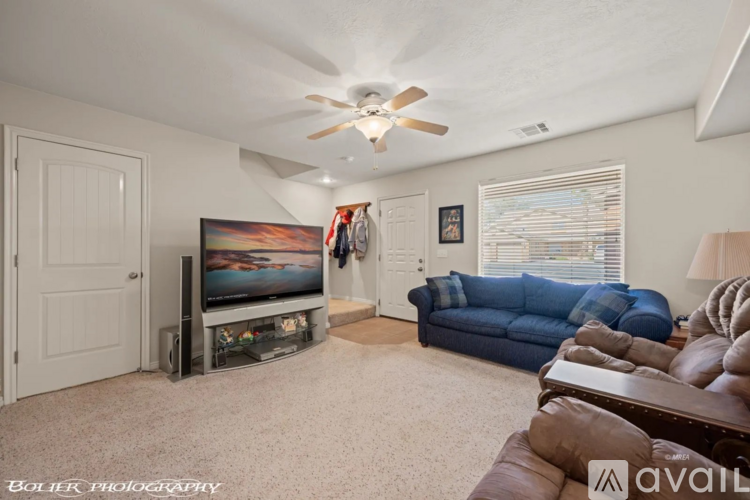 A living room with a blue couch and a television.