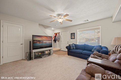 A living room with a blue couch and a television.