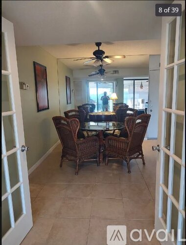 A dining room with a table set for six people.