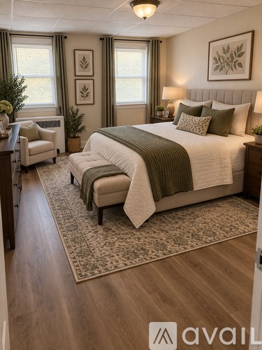 A bedroom with a large bed and a chair.
