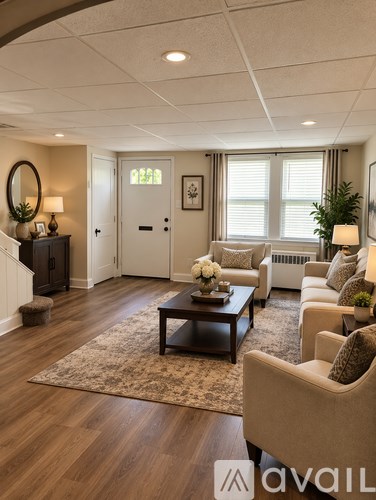 A living room with a brown coffee table and beige armchairs.